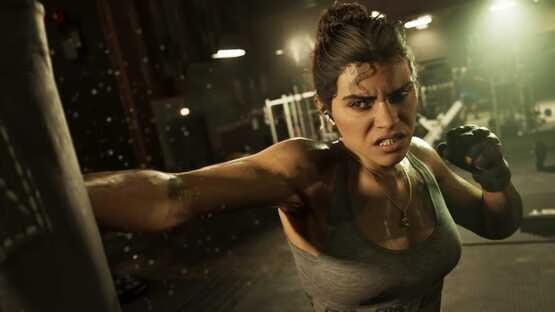 A screenshot from Grand Theft Auto VI (PlayStation 5) showing a determined woman punching a bag in a dimly lit gym.