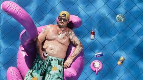 A Grand Theft Auto VI (PlayStation 5) screenshot showing a man relaxing on a pink float in a pool with scattered cans nearby.