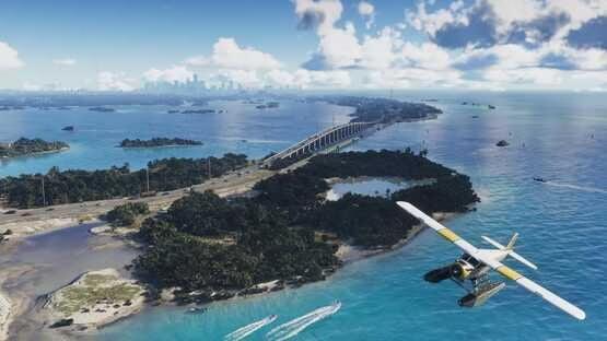 A Grand Theft Auto VI (PlayStation 5) screenshot showing a seaplane flying over a coastal bridge and islands under a blue sky.