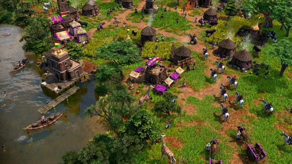 Screenshot from Age of Empires III: Definitive Edition - The African Royals showing a vibrant village by a river with villagers working.