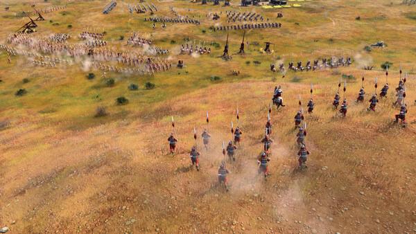 A screenshot from Age of Empires IV: Dynasties of the East showing cavalry charging towards an approaching enemy army on a grassy battlefield.
