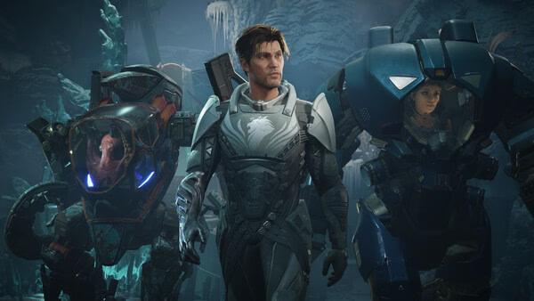 A screenshot from EXODUS showing a hero flanked by a robotic dog and a pilot in a mech suit in an icy cavern.
