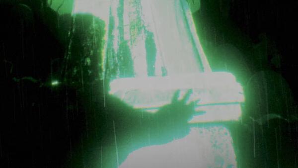 A screenshot from Persona 6 shows a glowing green scene with a shadowy figure reaching toward a mysterious light source.