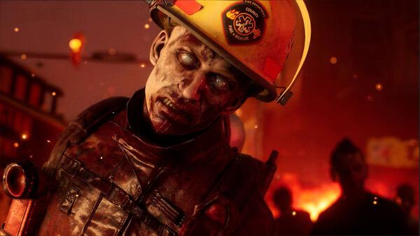 A screenshot from No More Room in Hell 2 showing a firefighter zombie with a helmet, surrounded by fiery chaos at night.