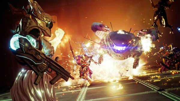 A Destiny 2 screenshot showing a Guardian aiming at a glowing enemy mech as explosions light up the battlefield.