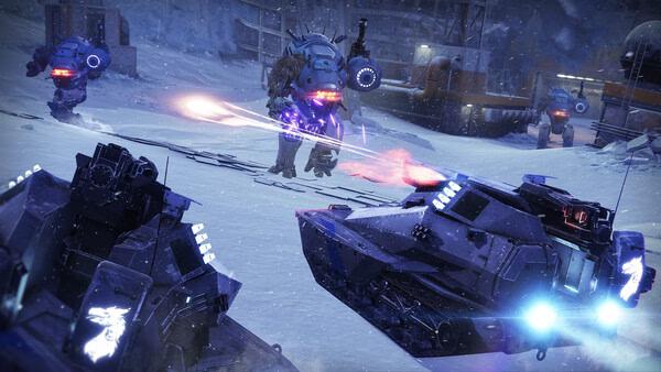 Destiny 2 screenshot of a snowy battlefield with tanks firing lasers and large robots advancing in the background.