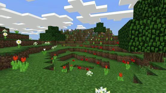 A screenshot of Minecraft: Java Edition showing a grassy landscape with flowers, trees, and a bright sky with clouds.