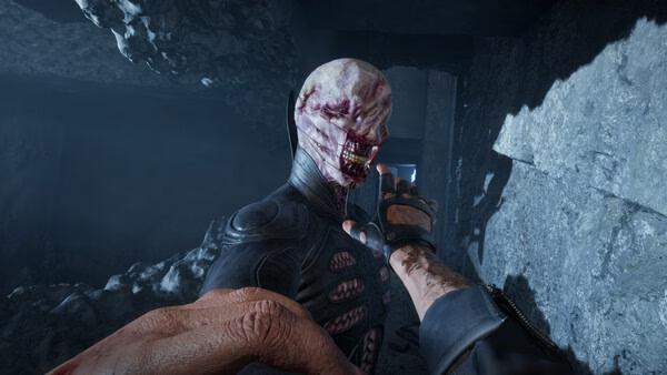 Clive Barker's Hellraiser: Revival screenshot: a bloody Pinhead-like Cenobite looms as a hand reaches toward him.