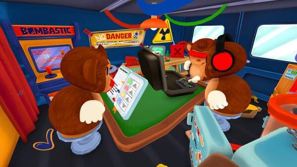 BOMBANANA! screenshot of two cartoon monkeys at a table with a laptop, tablet, and arcade machine in a colorful room.