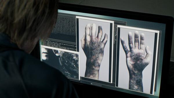 Resident Evil Requiem screenshot: A character examines a computer displaying images of infected hands with text data on the screen.