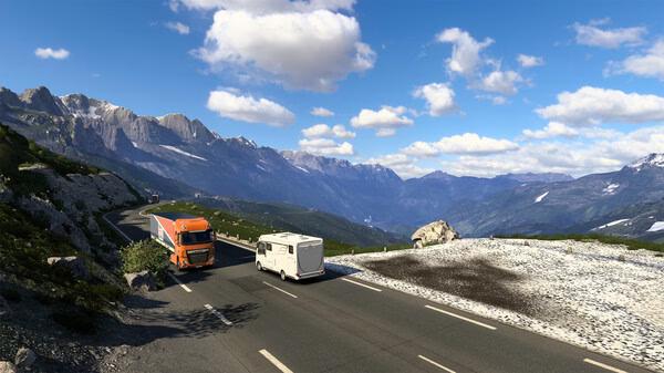 Euro Truck Simulator 2 screenshot: An orange truck driving on a mountain road with a scenic view of peaks and clouds.