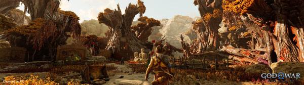 Screenshot from God of War Ragnarök showing a warrior exploring a vibrant, autumnal forest with large, twisted trees.