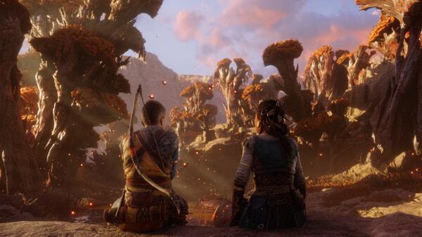 Screenshot from God of War Ragnarök showing two characters sitting in a vibrant, autumnal forest with glowing embers in the air.
