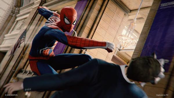 Screenshot from Marvel's Spider-Man Remastered showing Spider-Man swinging a punch at an enemy inside a grand hall.