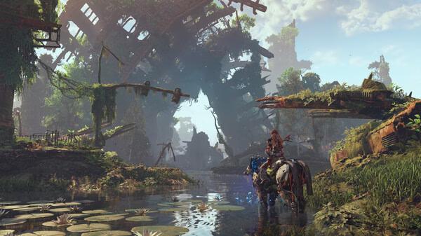 A screenshot from Horizon Zero Dawn™ Remastered showing Aloy riding a machine mount through a lush, overgrown ruin by a waterway.