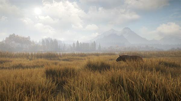 Screenshot from The Hunter Call of the Wild showing a lone deer walking through tall grass in a serene, mountainous landscape.