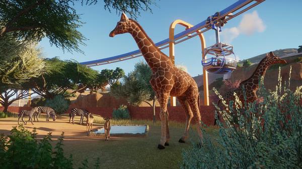 Planet Zoo screenshot: Giraffes and zebras roam a sunny savannah enclosure, with a monorail passing overhead in the background.
