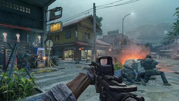 Gray Zone Warfare screenshot: A player aims an assault rifle in a street battle as teammates take cover near burning debris.