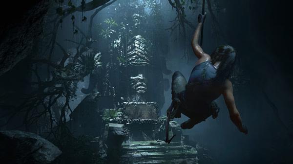 Lara Croft swings through a jungle towards a stone temple in this Shadow of the Tomb Raider screenshot.