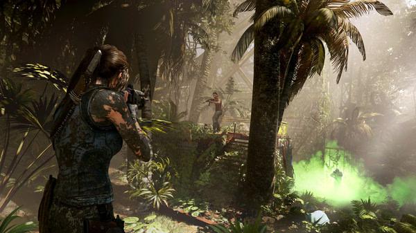Screenshot from Shadow of the Tomb Raider showing Lara Croft aiming a weapon in a lush jungle environment with ruins and green smoke.