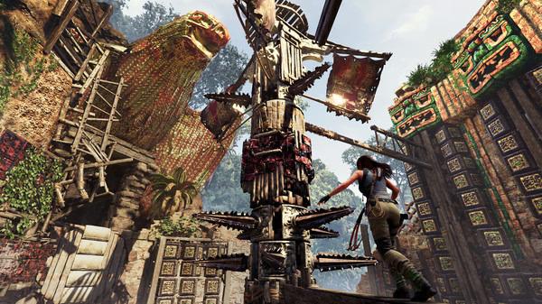 Lara Croft climbs a spiked rotating mechanism in a jungle temple in this Shadow of the Tomb Raider screenshot.
