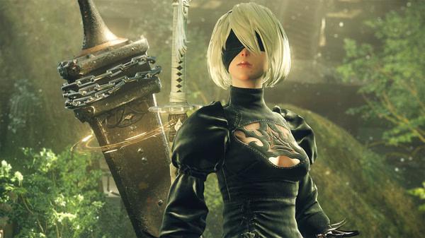 Screenshot from NieR:Automata™ showing a character in black attire standing in a lush, verdant landscape.