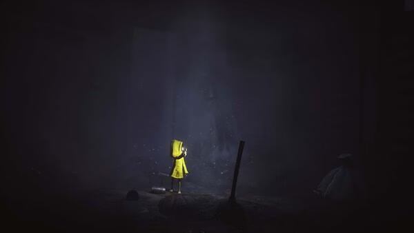 Screenshot from Little Nightmares showing a character in a yellow raincoat standing in a dark, eerie room with scattered debris.