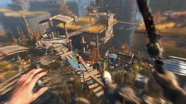 Dying Light 2 Stay Human: Reloaded Edition screenshot showing a player leaping between rooftops in a vibrant, post-apocalyptic urban landscape.