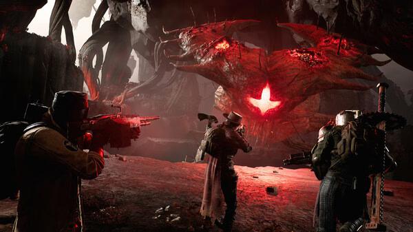 REMNANT II® screenshot: Three players aim weapons at a large, glowing red creature amidst a dark, cavernous landscape.
