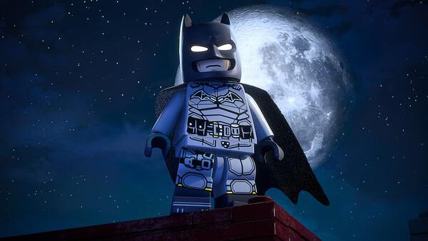 LEGO® Batman™: Legacy of the Dark Knight screenshot featuring LEGO Batman standing on a rooftop with a glowing moonlit sky.