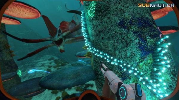 Subnautica screenshot: A player faces a large, red sea creature near glowing underwater plants while holding a handheld tool in the ocean.