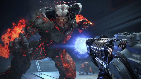 DOOM Eternal screenshot: A fiery demon charges forward as the player aims a weapon emitting a glowing blue energy blast.