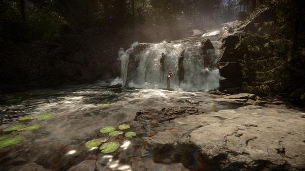 A screenshot from Sons Of The Forest showing a waterfall surrounded by lush forest, with a person standing in the water.