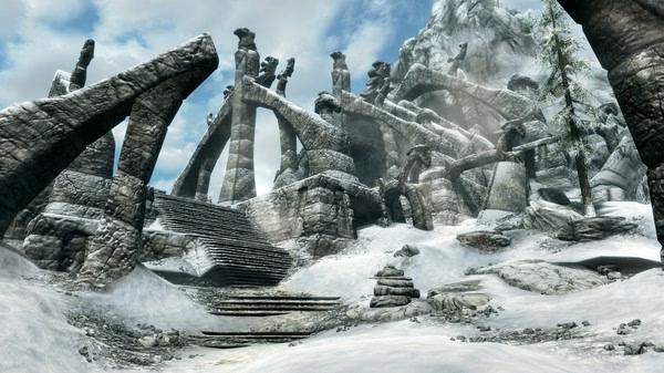 A screenshot from The Elder Scrolls V: Skyrim Special Edition showing a snowy ancient ruin with stone archways and stairs.