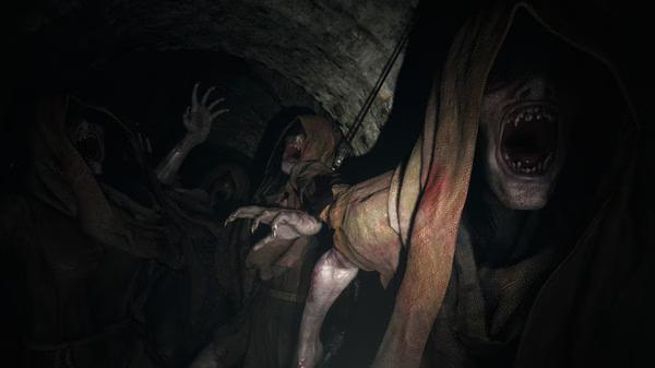Resident Evil Village screenshot: Hooded, snarling creatures with sharp teeth emerge from a dimly lit stone tunnel, reaching out aggressively.