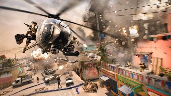 Battlefield™ 2042 screenshot: Helicopter flies over a chaotic urban battle scene with explosions and soldiers.