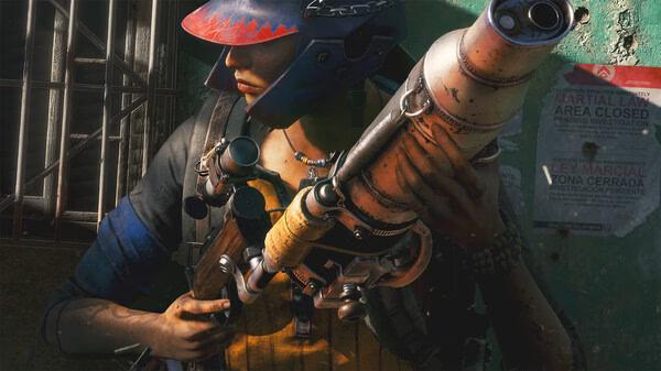 Screenshot from Far Cry® 6 showing a character holding a large weapon in a dimly lit room with posters on the wall.