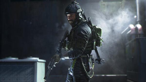 A soldier in tactical gear holds a rifle in a dimly lit room in this 'Call of Duty®: Modern Warfare® II' screenshot.