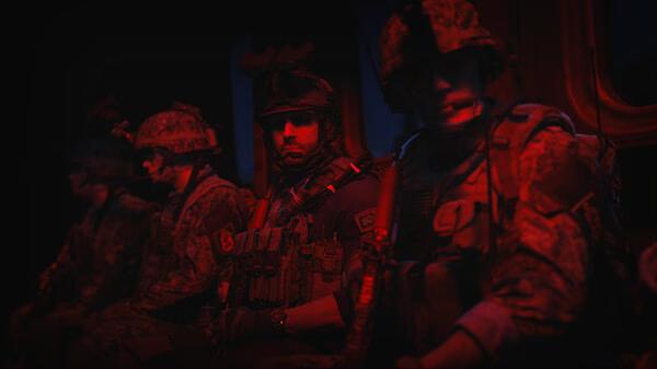 Screenshot from Call of Duty®: Modern Warfare® II showing soldiers in tactical gear seated inside a dimly lit military transport.