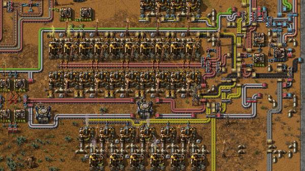 This Factorio screenshot displays a complex factory assembly line with conveyor belts, machines, and resources on a desert terrain.
