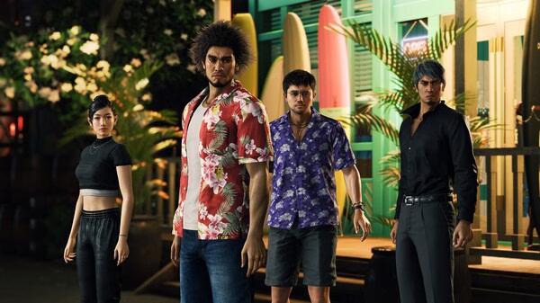 Screenshot from Like a Dragon: Infinite Wealth showing four characters standing outside a building with surfboards visible in the background.