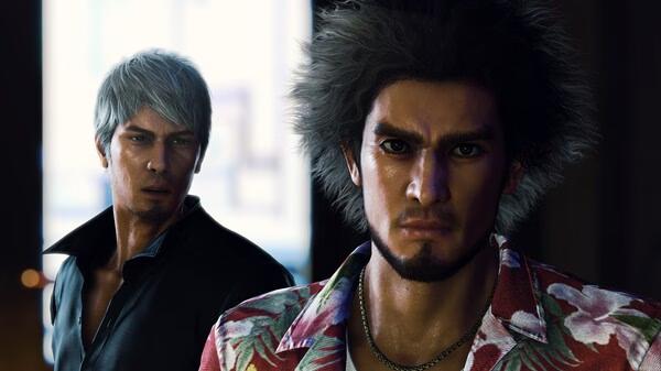 Screenshot from Like a Dragon: Infinite Wealth showing two characters, one with gray hair and another in a floral shirt, standing indoors.