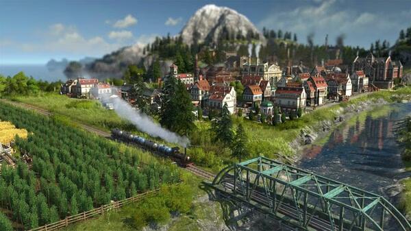 Anno 1800 screenshot: A scenic town with houses, a train on tracks, green fields, and a river with a bridge in the foreground.