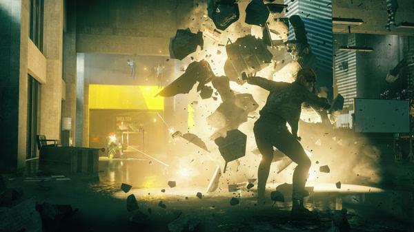 Screenshot from CONTROL Ultimate Edition showing a character using telekinesis to shatter debris in a spacious, modern interior.