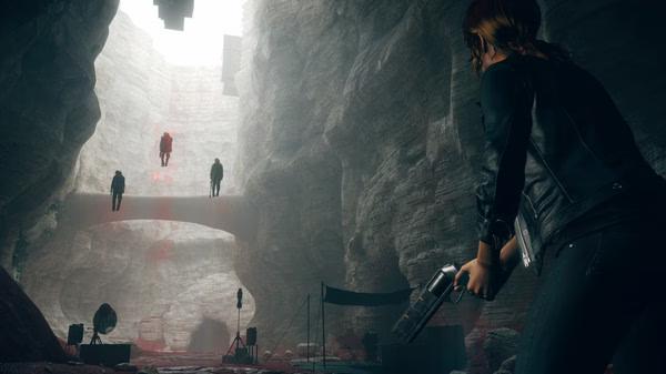 Screenshot from CONTROL Ultimate Edition showing the protagonist aiming a weapon at three levitating enemies in a rocky, cavernous area.