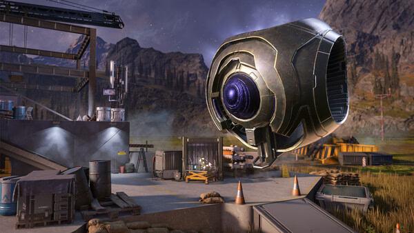 Halo Infinite screenshot showing a large floating robot in a futuristic outdoor base surrounded by mountains and construction materials.
