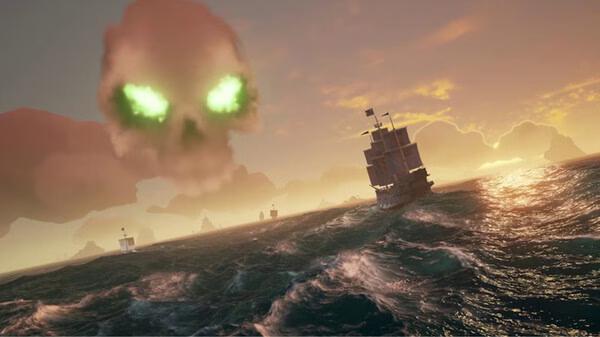 Sea of Thieves: 2026 Edition screenshot showing a ship sailing toward a menacing green-eyed skull cloud on a turbulent sea at sunset.