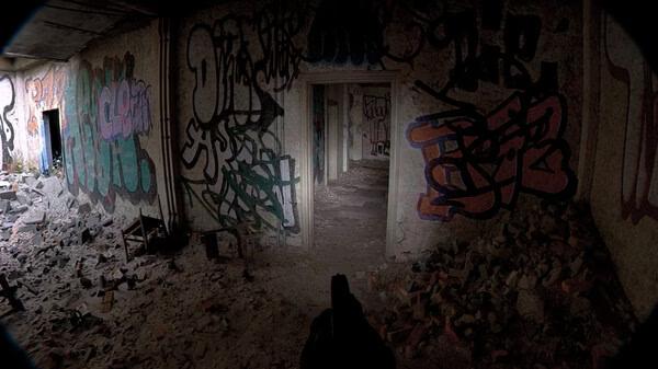 Screenshot from Unrecord showing a first-person view of a pistol aimed down a graffiti-covered, dilapidated hallway.