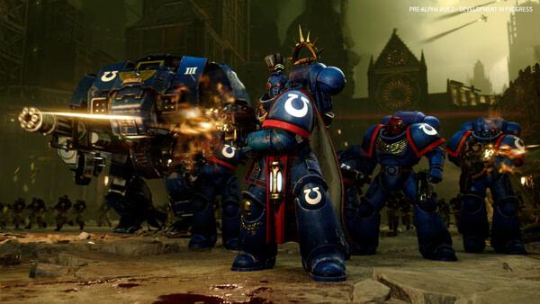 Total War: WARHAMMER 40,000 screenshot: Space Marines in blue armor firing guns amidst a battle in a gothic cityscape.