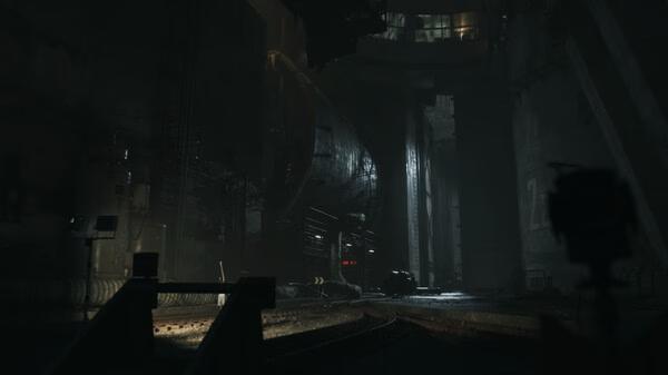 A screenshot from the game ILL showing a dark, industrial environment with large machinery and dim lighting.